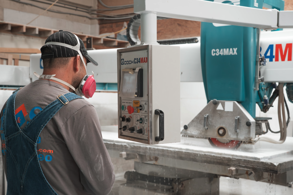 ES Staff member using a CNC machine to cut granite